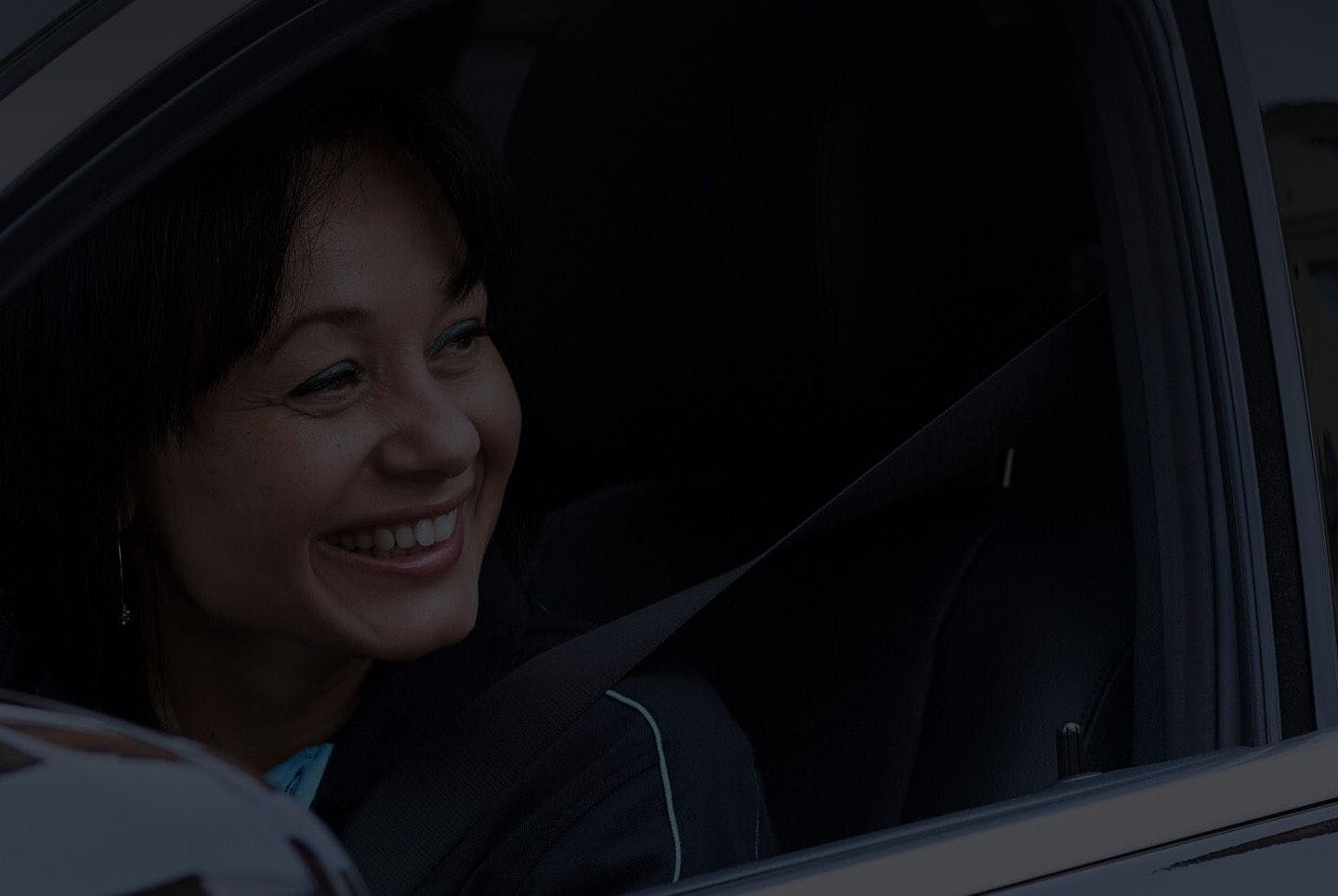 Woman smiling in a cab